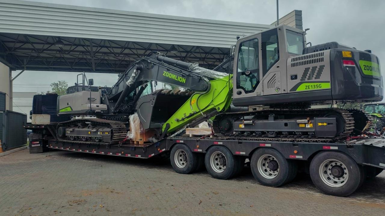 Retroescavadeiras de grande porte carregadas em prancha para transporte